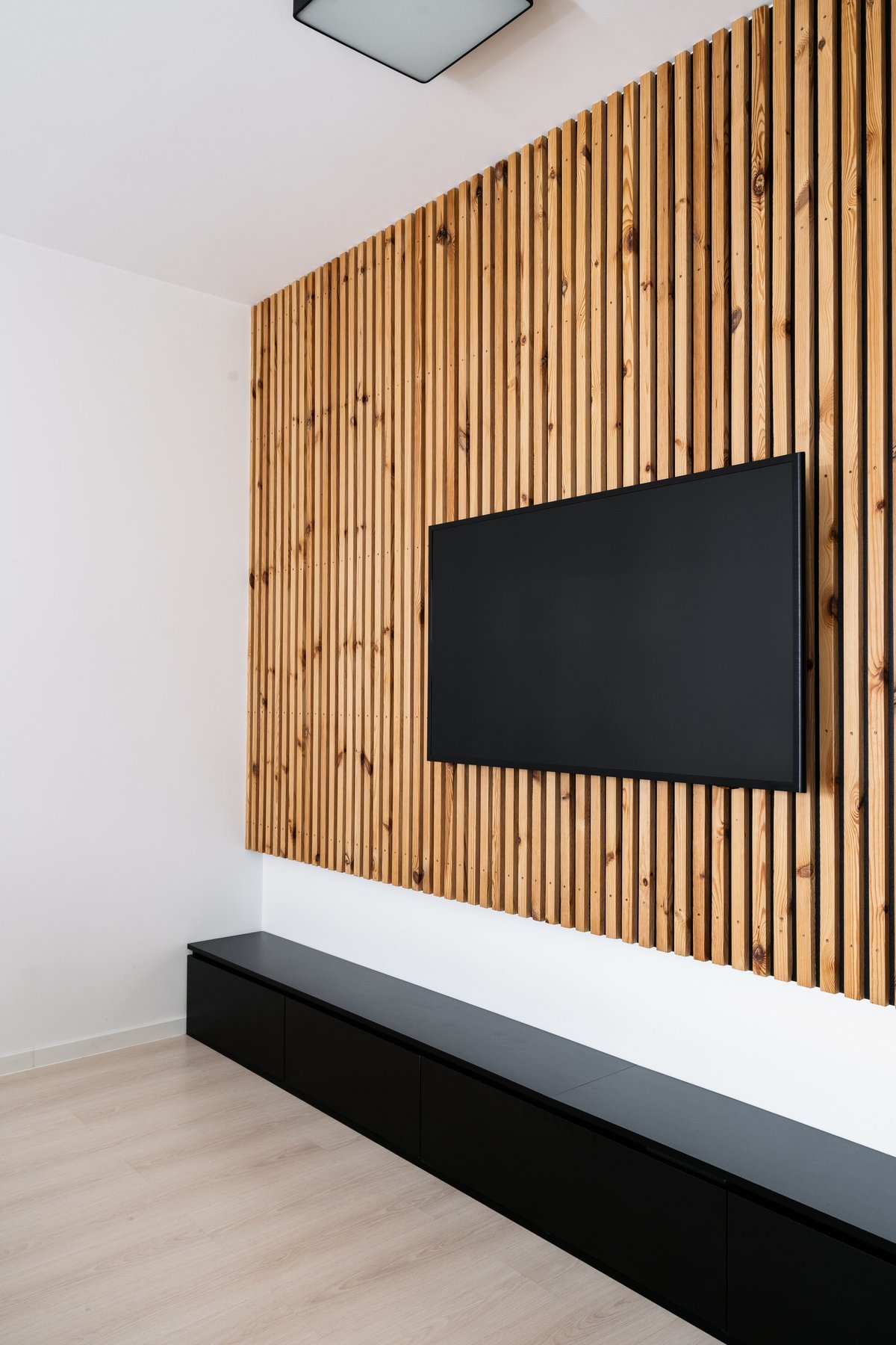 Home cinema, smart tv. Flat screen television is mounted on wall in a contemporary living room.